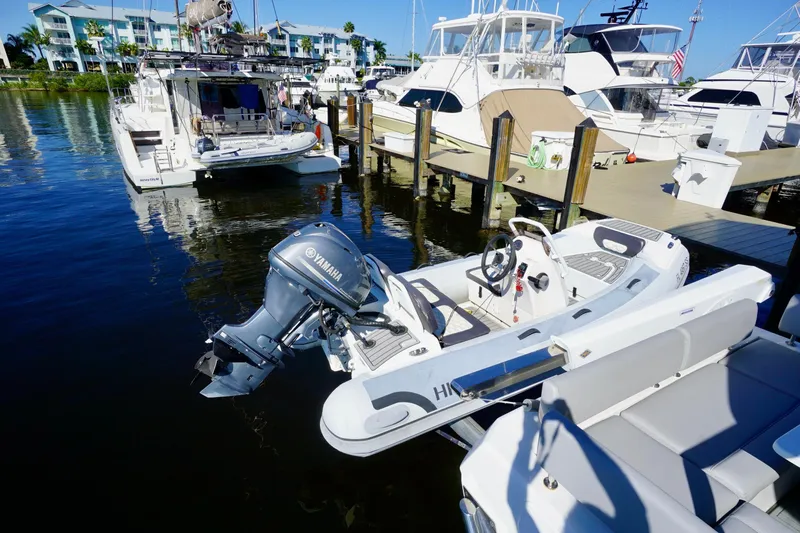  Yacht Photos Pics Docked Aquila 44 Yacht, 2020 model, with Yamaha outboard motor in marina.