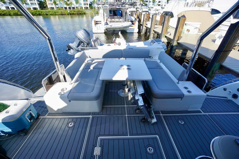  Yacht Photos Pics Aquila 44 Yacht 2020 with spacious deck seating and table, docked by the water.