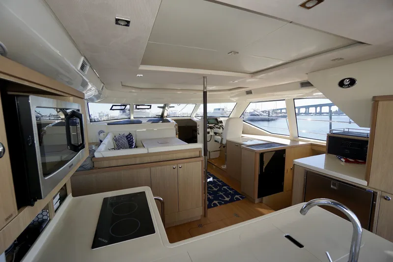  Yacht Photos Pics Luxurious interior of 2020 Aquila 44 Yacht with modern kitchen and panoramic windows.
