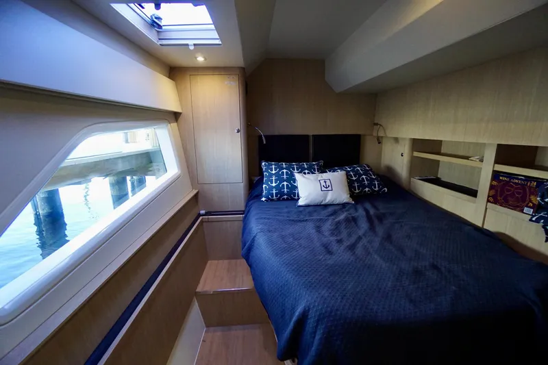  Yacht Photos Pics Luxurious cabin interior of 2020 Aquila 44 Yacht with nautical-themed bedding.