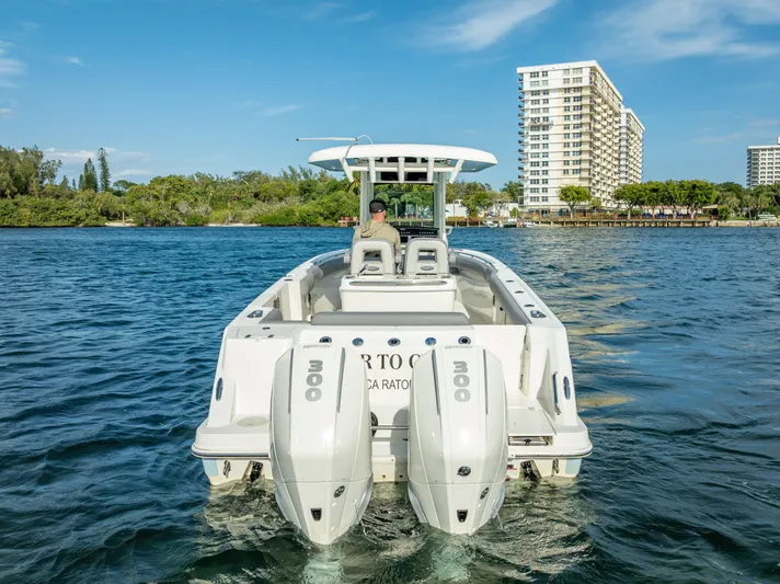 Clear To Close Yacht Photos Pics 2023 Boston Whaler 280 Outrage boat on water, cityscape in background.