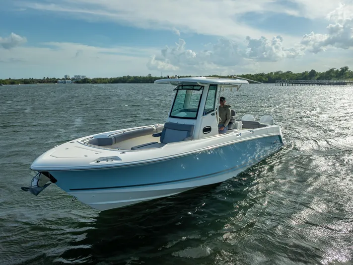 Clear To Close Yacht Photos Pics 2023 Boston Whaler 280 Outrage boat cruising on open water under a cloudy sky.