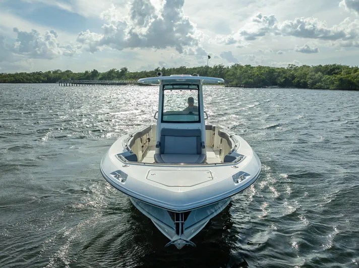 Clear To Close Yacht Photos Pics 2023 Boston Whaler 280 Outrage on open water, front view with scenic background.