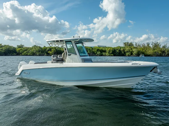 Clear To Close Yacht Photos Pics 2023 Boston Whaler 280 Outrage boat on a sunny day, cruising on a calm lake.