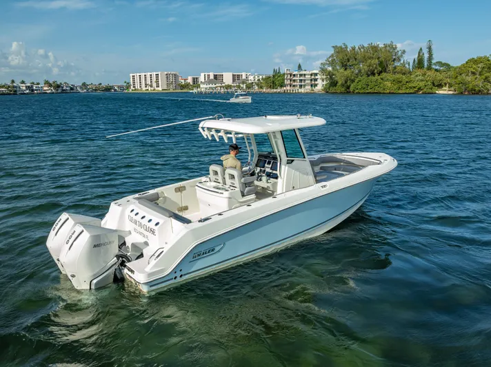 Clear To Close Yacht Photos Pics 2023 Boston Whaler 280 Outrage boat cruising on a scenic waterway.