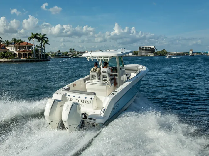 Clear To Close Yacht Photos Pics 2023 Boston Whaler 280 Outrage cruising on a sunny day in a scenic waterway.