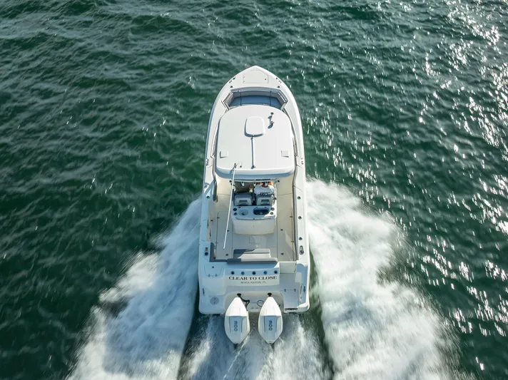 Clear To Close Yacht Photos Pics 2023 Boston Whaler 280 Outrage cruising on open water, aerial view.