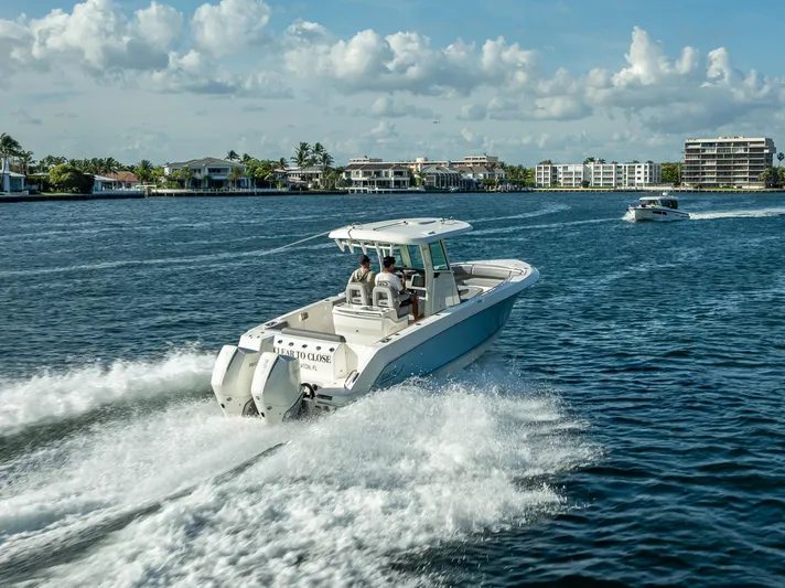 Clear To Close Yacht Photos Pics 2023 Boston Whaler 280 Outrage cruising on a sunny day in a coastal area.