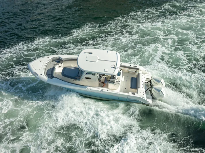 Clear To Close Yacht Photos Pics 2023 Boston Whaler 280 Outrage cruising on open water, aerial view.