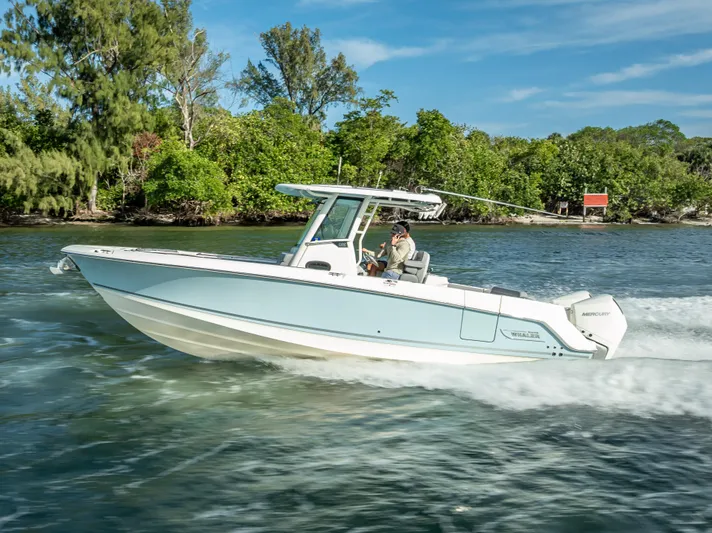 Clear To Close Yacht Photos Pics 2023 Boston Whaler 280 Outrage cruising on a scenic waterway.