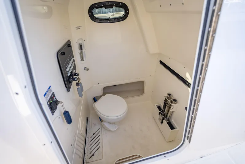Clear To Close Yacht Photos Pics Interior of 2023 Boston Whaler 280 Outrage boat, featuring a compact marine toilet.