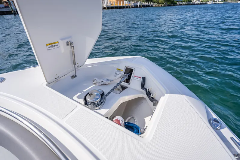 Clear To Close Yacht Photos Pics 2023 Boston Whaler 280 Outrage boat anchor compartment with open hatch on water.