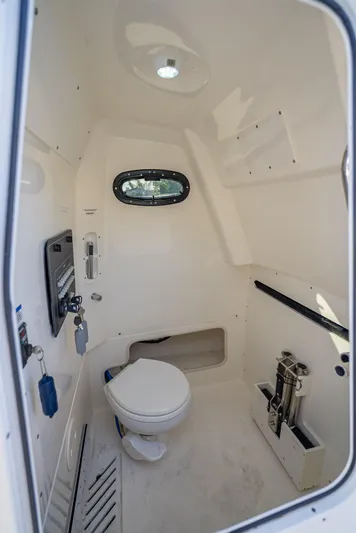 Clear To Close Yacht Photos Pics Interior of 2023 Boston Whaler 280 Outrage boat, featuring a compact marine toilet.