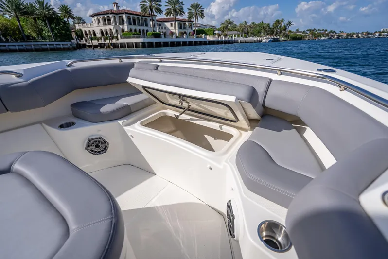 Clear To Close Yacht Photos Pics 2023 Boston Whaler 280 Outrage interior with open storage, luxurious seating, and waterfront view.