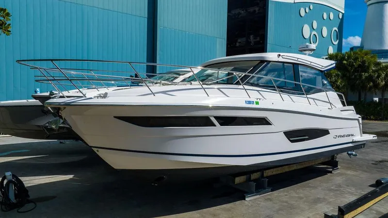 2021 Regal 38 Xo Yacht Photos Pics 2021 Regal 38 XO yacht docked outdoors near a blue building.