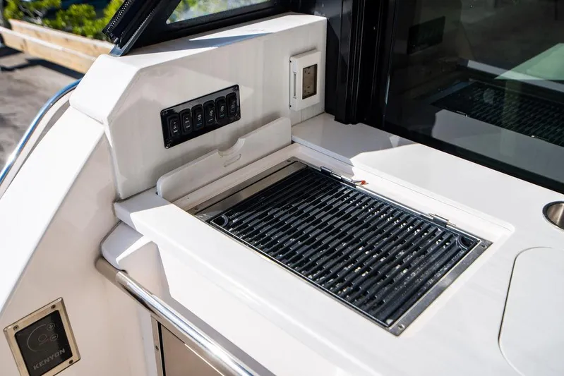 2021 Regal 38 Xo Yacht Photos Pics Outdoor grill on 2021 Regal 38 XO yacht deck, featuring sleek design and control panel.