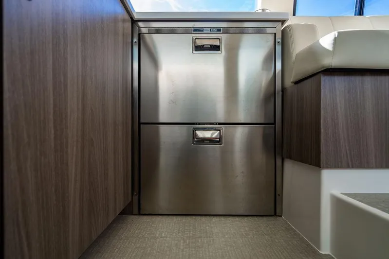 2021 Regal 38 Xo Yacht Photos Pics 2021 Regal 38 XO yacht interior with stainless steel drawers and wood paneling.