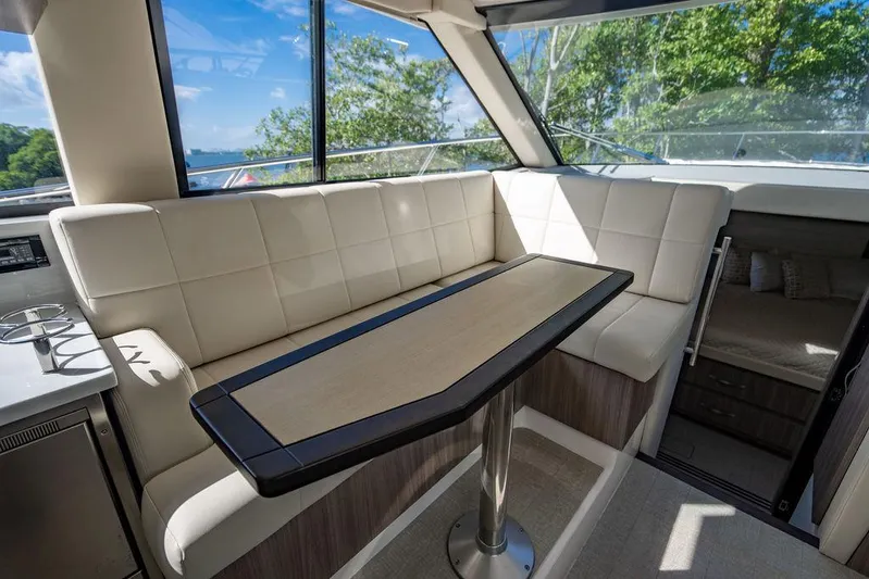 2021 Regal 38 Xo Yacht Photos Pics Interior of 2021 Regal 38 XO yacht with elegant seating and table.