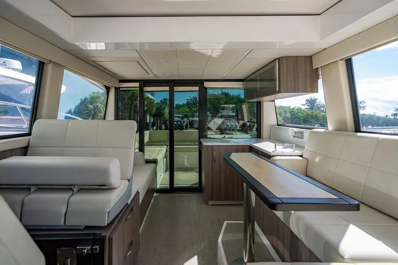 2021 Regal 38 Xo Yacht Photos Pics Luxurious interior of 2021 Regal 38 XO yacht with modern seating and panoramic windows.