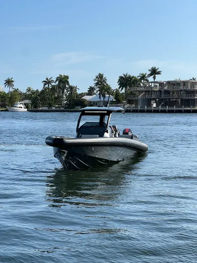 Pre-owned Skipper 38 Yacht Photos Pics 2024 Skipper 38 boat cruising on a sunny day in a tropical waterfront area.