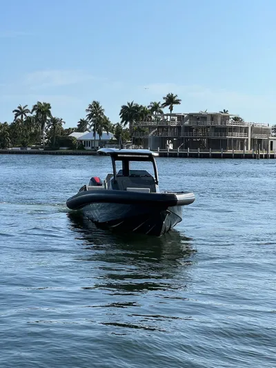 Pre-owned Skipper 38 Yacht Photos Pics 2024 Skipper 38 boat cruising on a sunny day near waterfront homes.