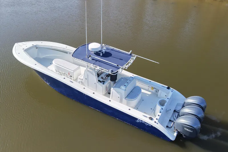  Yacht Photos Pics 2006 Yellowfin 36 Offshore boat with triple Yamaha engines on calm water.