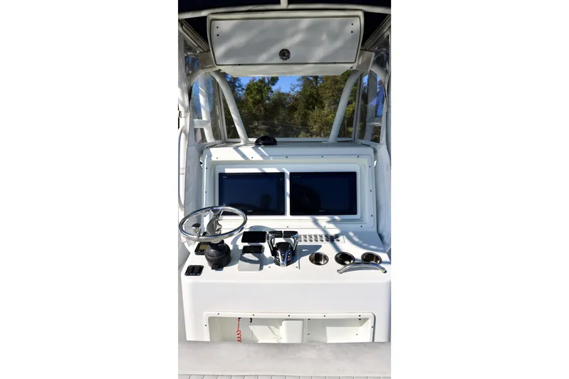  Yacht Photos Pics 2006 Yellowfin 36 Offshore boat helm with steering wheel and navigation screens.