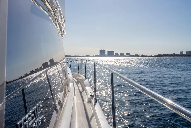 Knightlife Yacht Photos Pics Prestige 630 yacht cruising on sunny waters, reflecting city skyline, 2017 model.