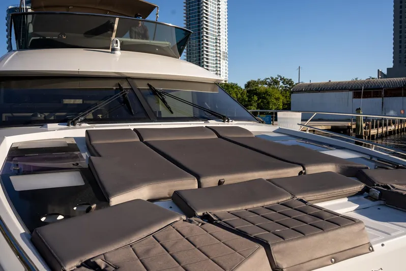 Knightlife Yacht Photos Pics Luxury 2017 Prestige 630 yacht with sunbathing deck, docked near urban skyline.
