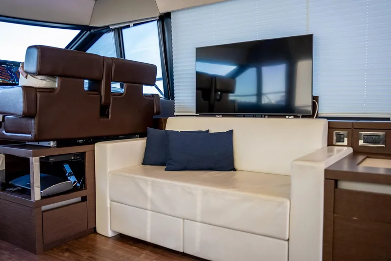 Knightlife Yacht Photos Pics Luxurious interior of 2017 Prestige 630 yacht with sofa and TV.