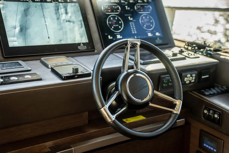 Knightlife Yacht Photos Pics Steering wheel and dashboard of 2017 Prestige 630 yacht with navigation screens.