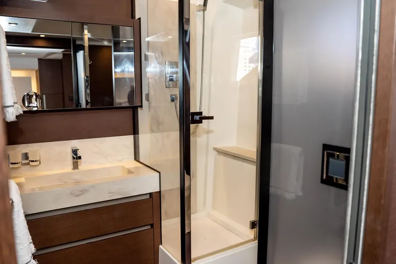 Knightlife Yacht Photos Pics Luxurious bathroom in 2017 Prestige 630 yacht with modern fixtures and glass shower.