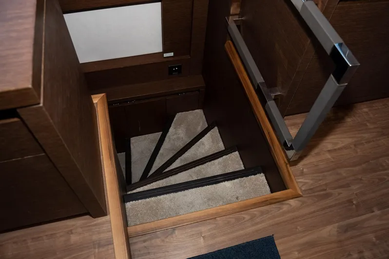 Knightlife Yacht Photos Pics Staircase inside 2017 Prestige 630 yacht with wooden finish and carpeted steps.