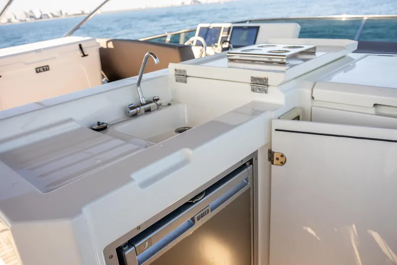 Knightlife Yacht Photos Pics Outdoor kitchen on 2017 Prestige 630 yacht with sink and mini fridge.