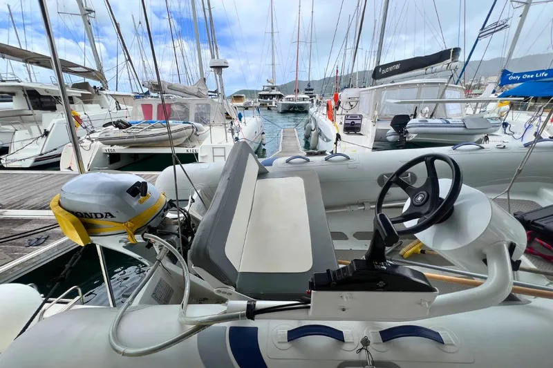 Ile En Ile Yacht Photos Pics 2018 Lagoon 42 yacht with Honda outboard motor in marina setting.