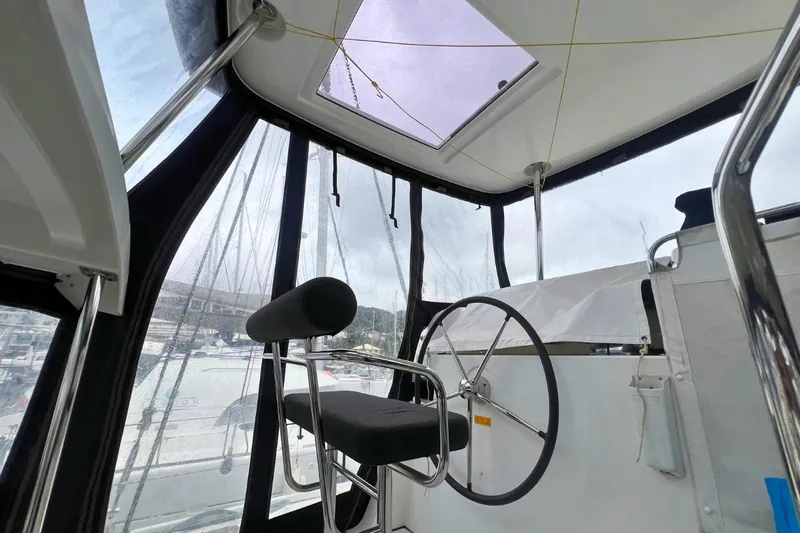 Ile En Ile Yacht Photos Pics Interior view of 2018 Lagoon 42 yacht cockpit with steering wheel and seating.