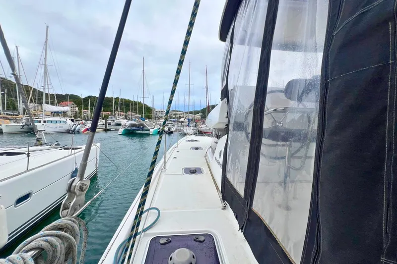 Ile En Ile Yacht Photos Pics 2018 Lagoon 42 catamaran docked in a marina, surrounded by other boats.