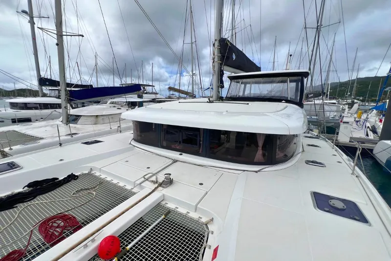 Ile En Ile Yacht Photos Pics 2018 Lagoon 42 catamaran docked at marina, overcast sky, multiple sailboats in background.