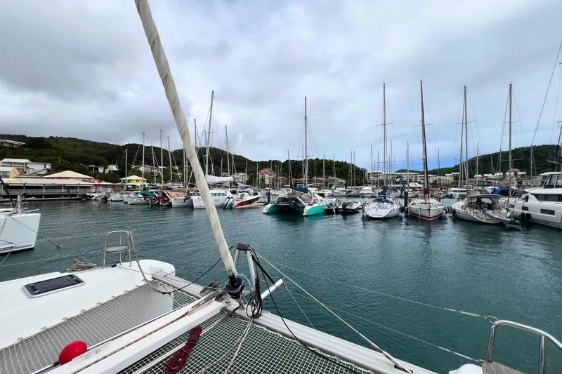 Ile En Ile Yacht Photos Pics Marina view with Lagoon 42 catamaran, 2018 model, surrounded by sailboats and cloudy sky.