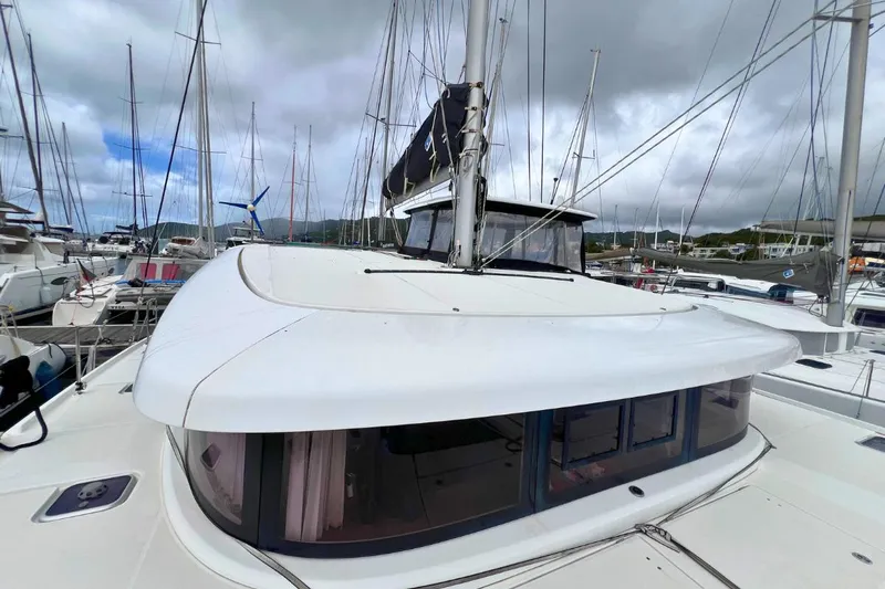 Ile En Ile Yacht Photos Pics 2018 Lagoon 42 catamaran docked at marina, featuring sleek design and spacious deck.