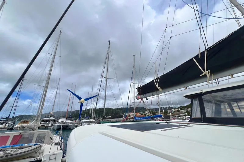 Ile En Ile Yacht Photos Pics 2018 Lagoon 42 catamaran docked in a marina under cloudy skies.