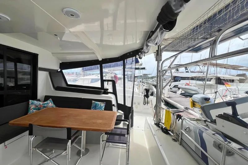 Ile En Ile Yacht Photos Pics 2018 Lagoon 42 catamaran cockpit with dining area and marina view.