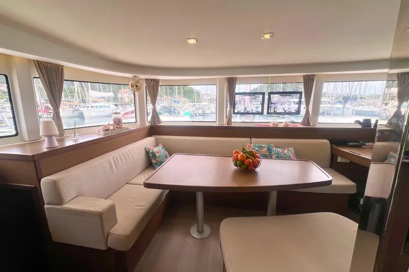 Ile En Ile Yacht Photos Pics Interior of 2018 Lagoon 42 catamaran with cozy seating and dining area.
