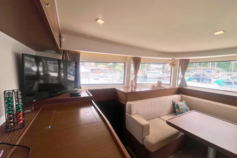 Ile En Ile Yacht Photos Pics Interior of 2018 Lagoon 42 catamaran with cozy seating and large windows.