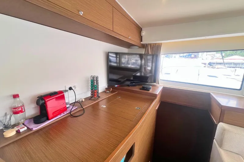 Ile En Ile Yacht Photos Pics Interior of 2018 Lagoon 42 yacht with TV, coffee maker, and window view.