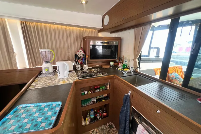 Ile En Ile Yacht Photos Pics Modern kitchen interior of 2018 Lagoon 42 catamaran with appliances and storage.