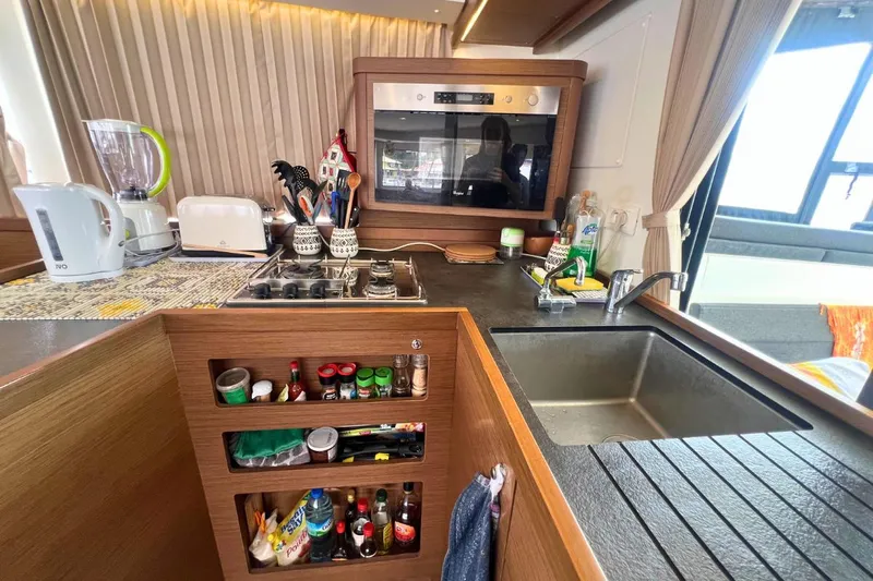 Ile En Ile Yacht Photos Pics Modern kitchen in 2018 Lagoon 42 yacht with appliances and organized storage.