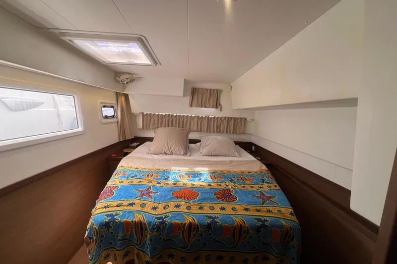 Ile En Ile Yacht Photos Pics Cozy cabin interior of 2018 Lagoon 42 catamaran with colorful bedding and natural light.