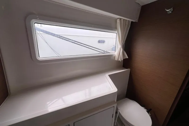 Ile En Ile Yacht Photos Pics Interior of 2018 Lagoon 42 yacht bathroom with window and toilet.