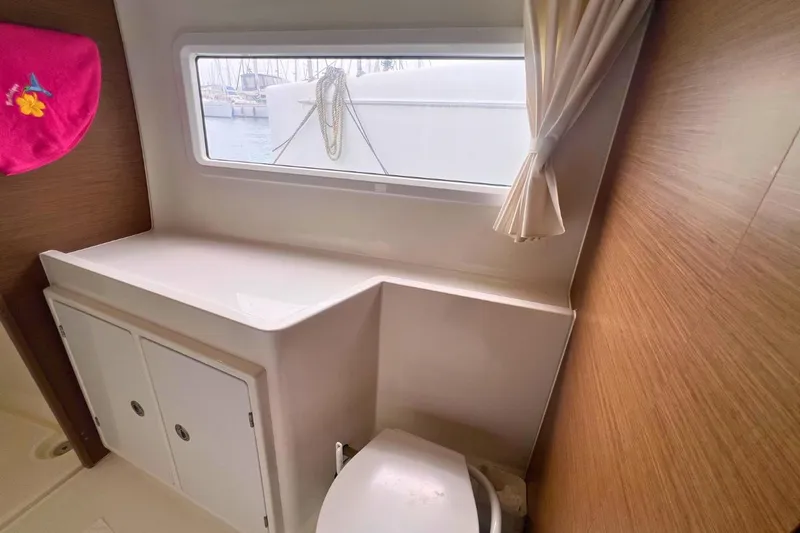 Ile En Ile Yacht Photos Pics Interior of 2018 Lagoon 42 yacht bathroom with window and storage cabinets.
